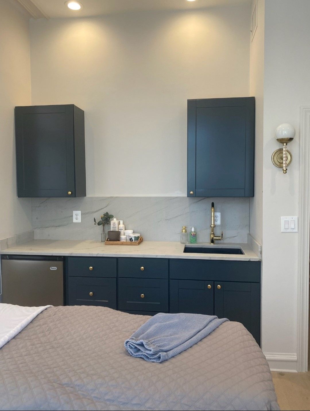 A kitchen with blue cabinets and a sink