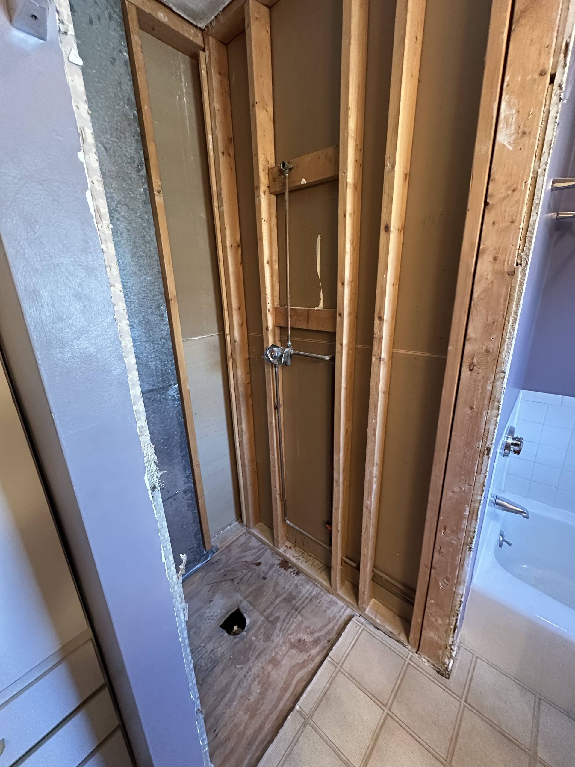 A bathroom with a bathtub and shower under construction.