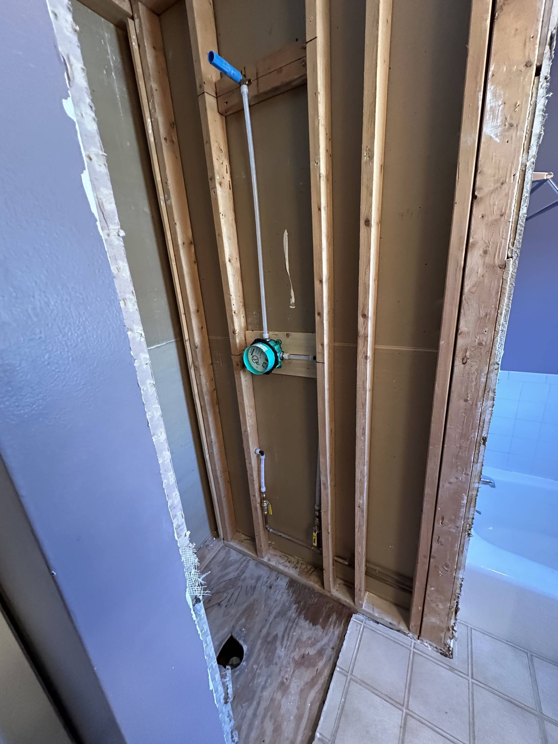 A bathroom is being remodeled and a shower is being installed.