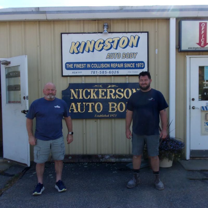 Two men standing outside Nickerson Auto Body and Kingston sign on a sunny day