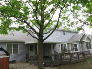 A house with a large tree in front of it