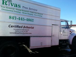 A white truck is parked on the side of the road.