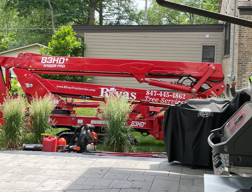 A red crane is parked in front of a house.
