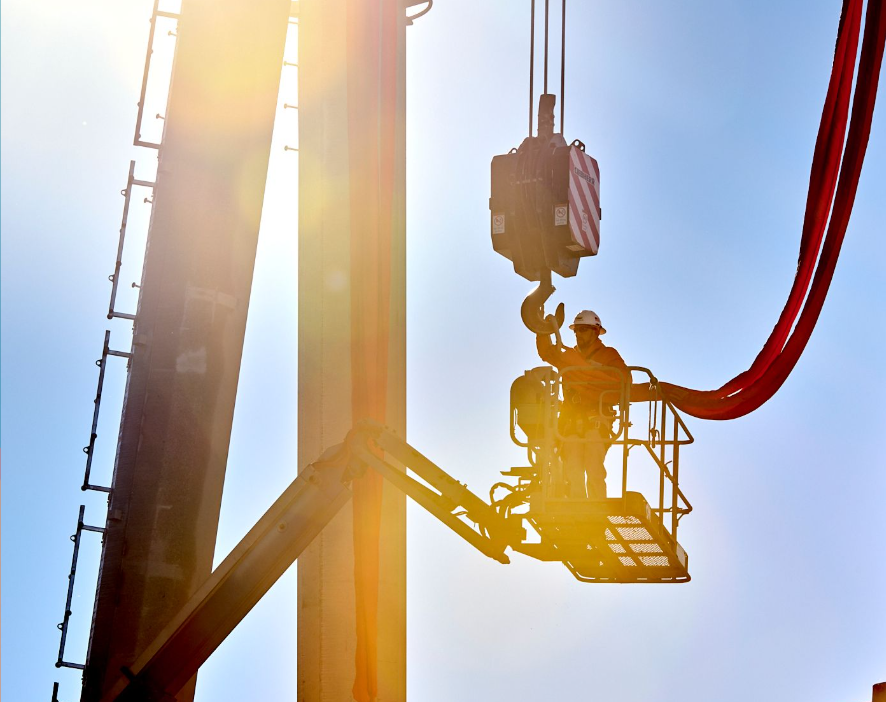 a man in a bucket is working on a crane