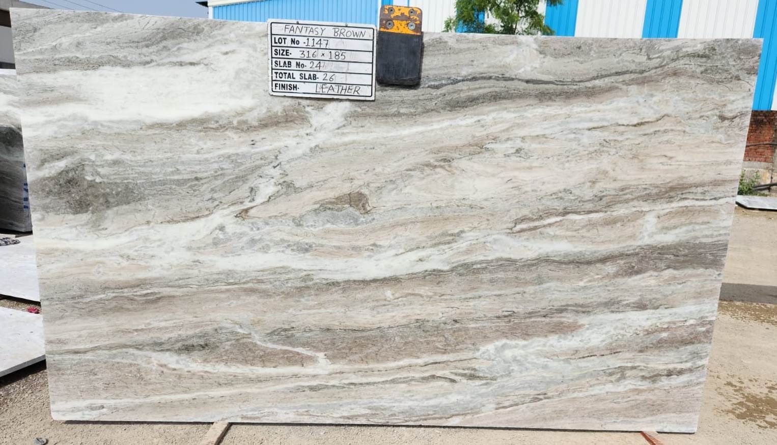 A large slab of granite is sitting on a wooden stand.