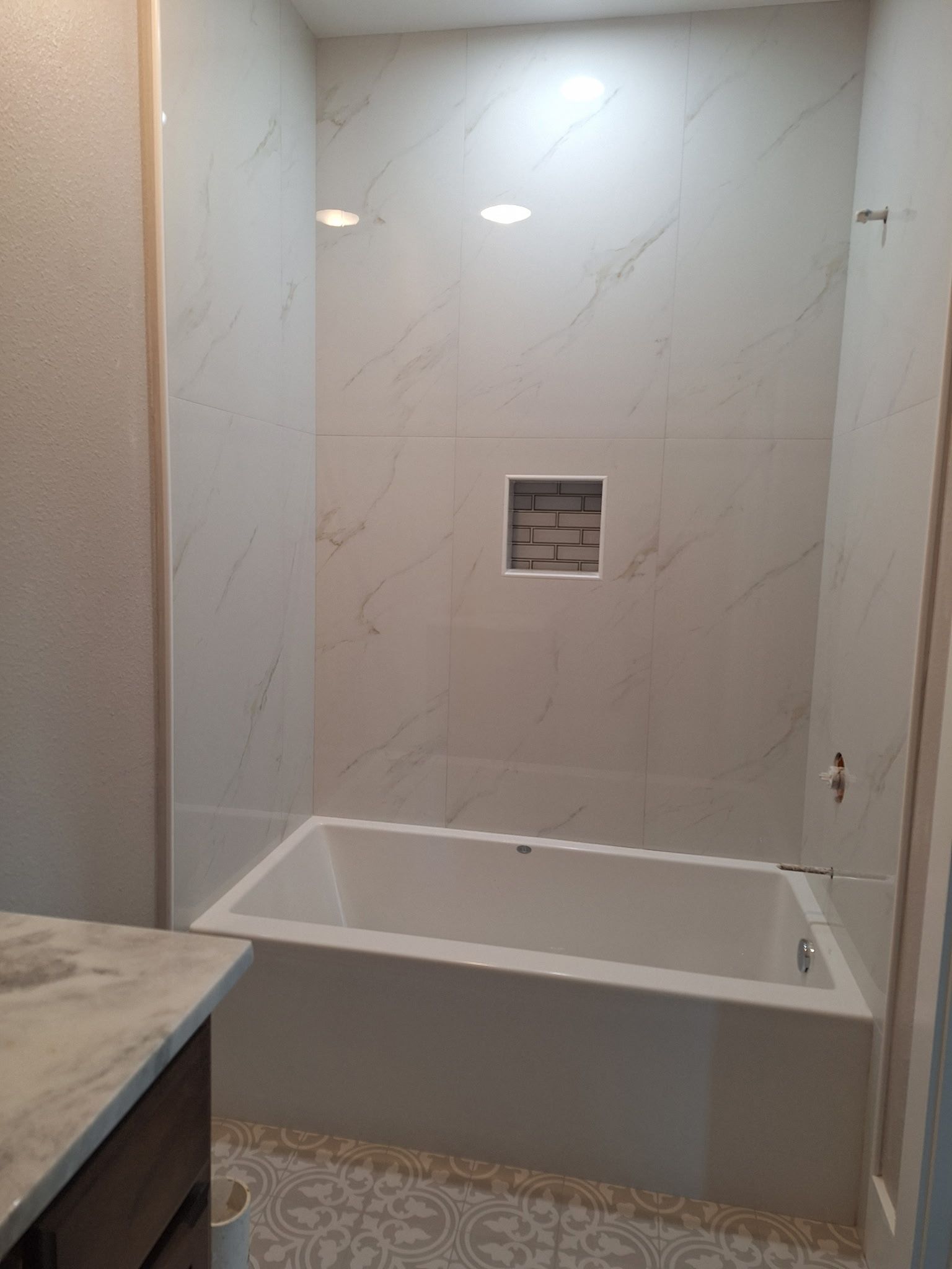 A bathroom with a bathtub and a shower.