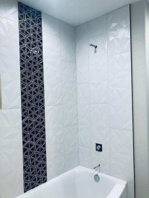 A bathroom with a bathtub and a shower.