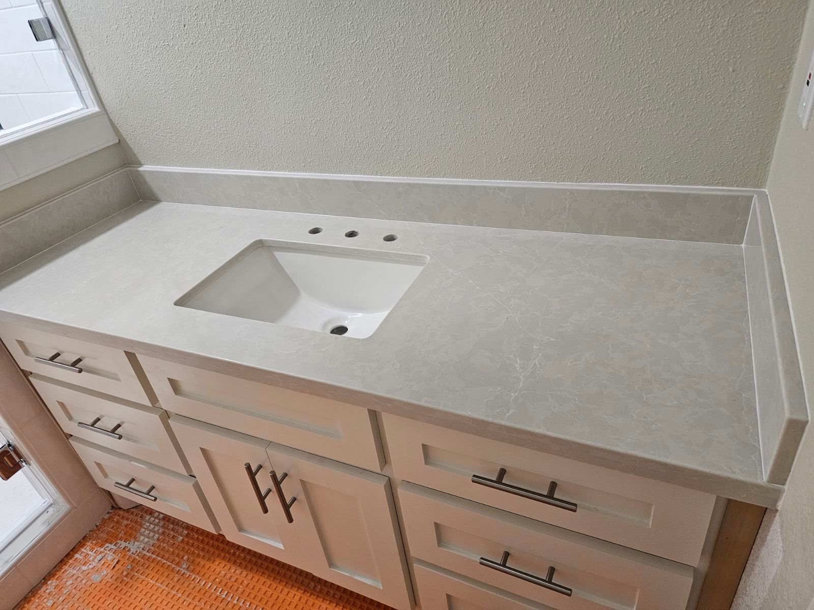 A bathroom vanity with a sink and drawers