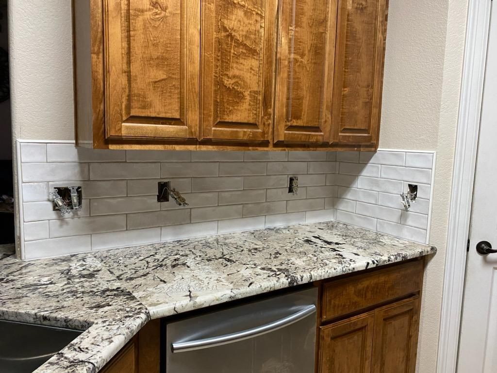 A kitchen with granite counter tops , stainless steel appliances , and wooden cabinets.