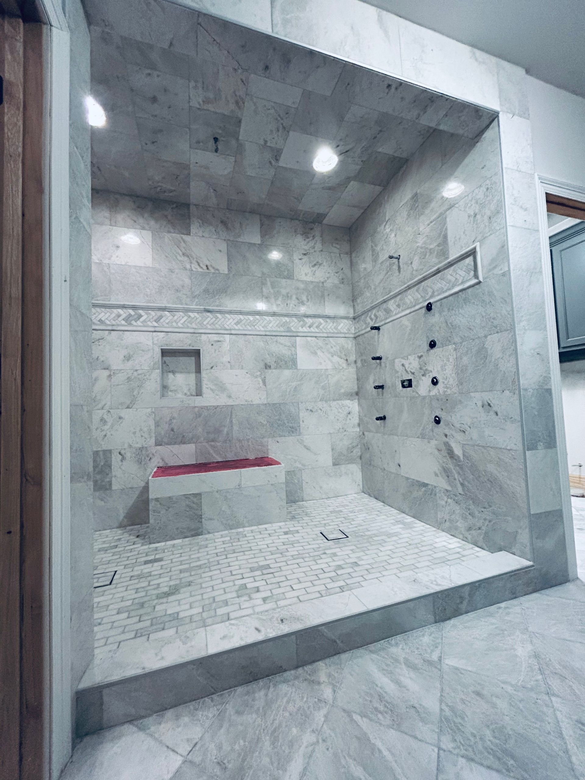 A bathroom with a walk in shower and a bathtub.