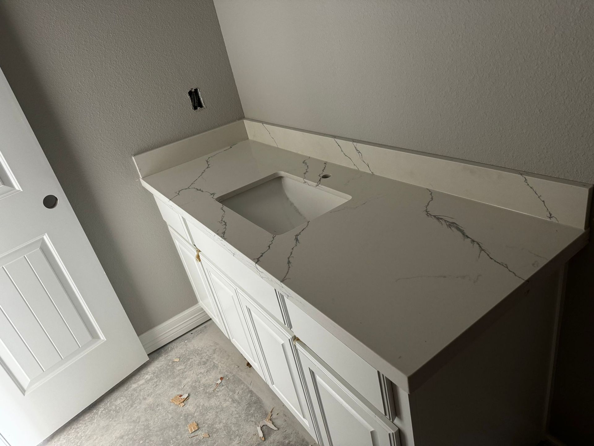 A bathroom vanity with a sink on top of it.