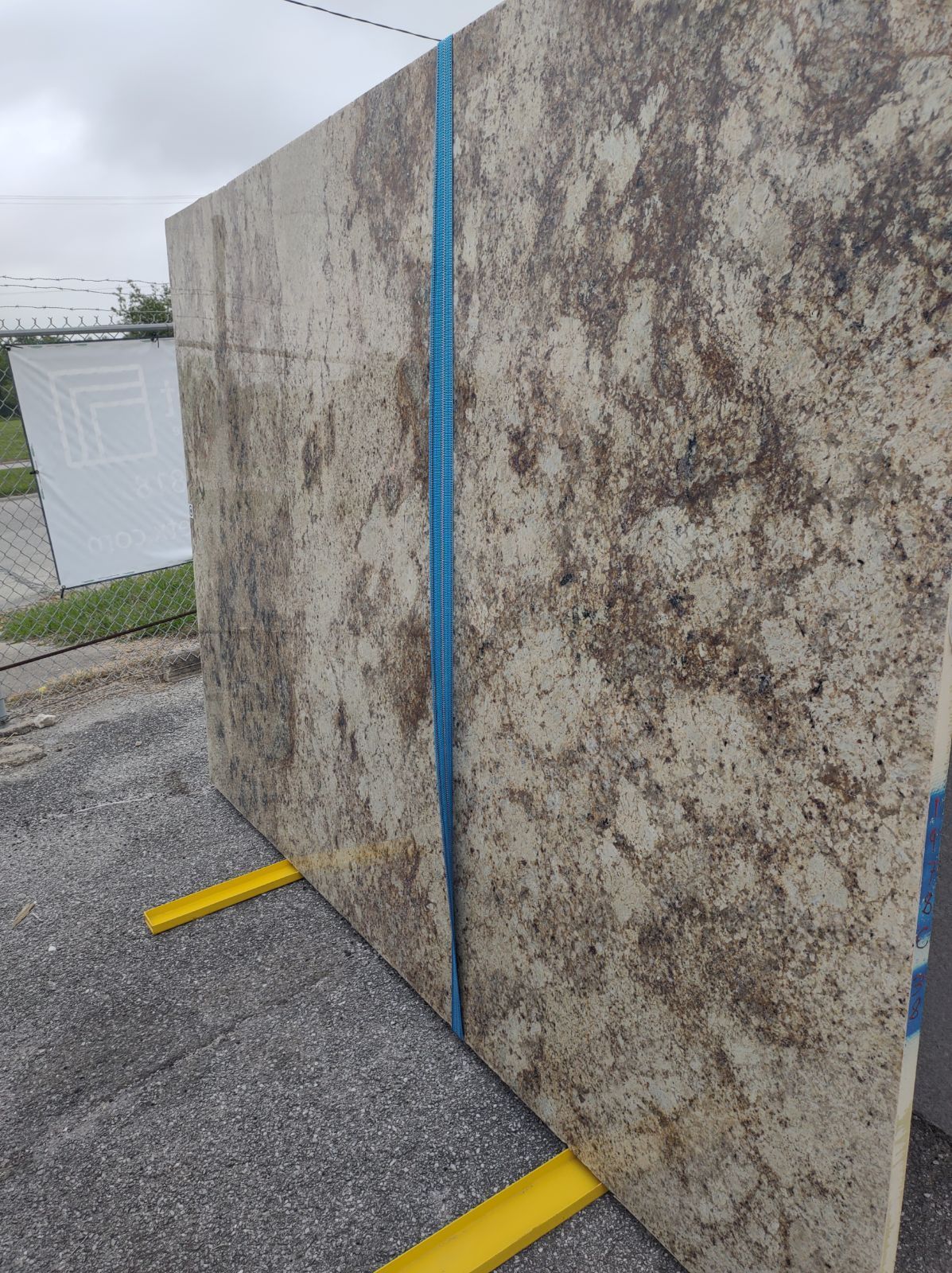 A large slab of granite is sitting on top of a concrete surface.