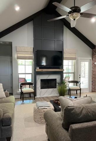 A living room with a fireplace and a flat screen tv.