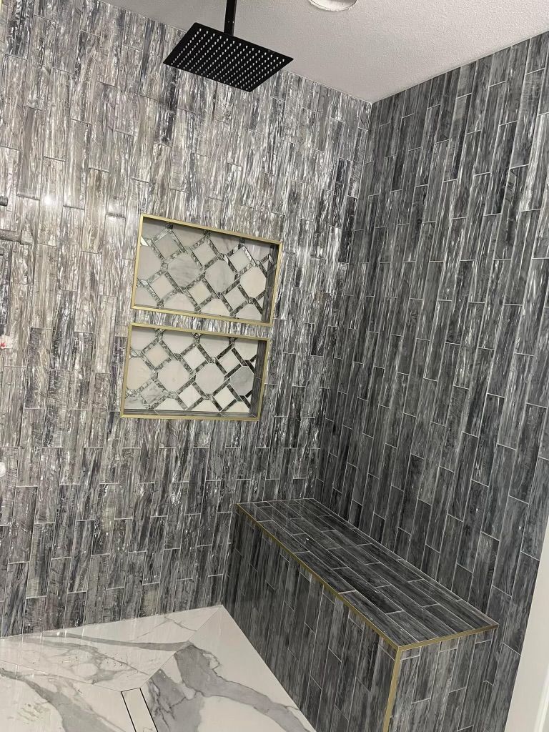 A bathroom with a shower head and a window.