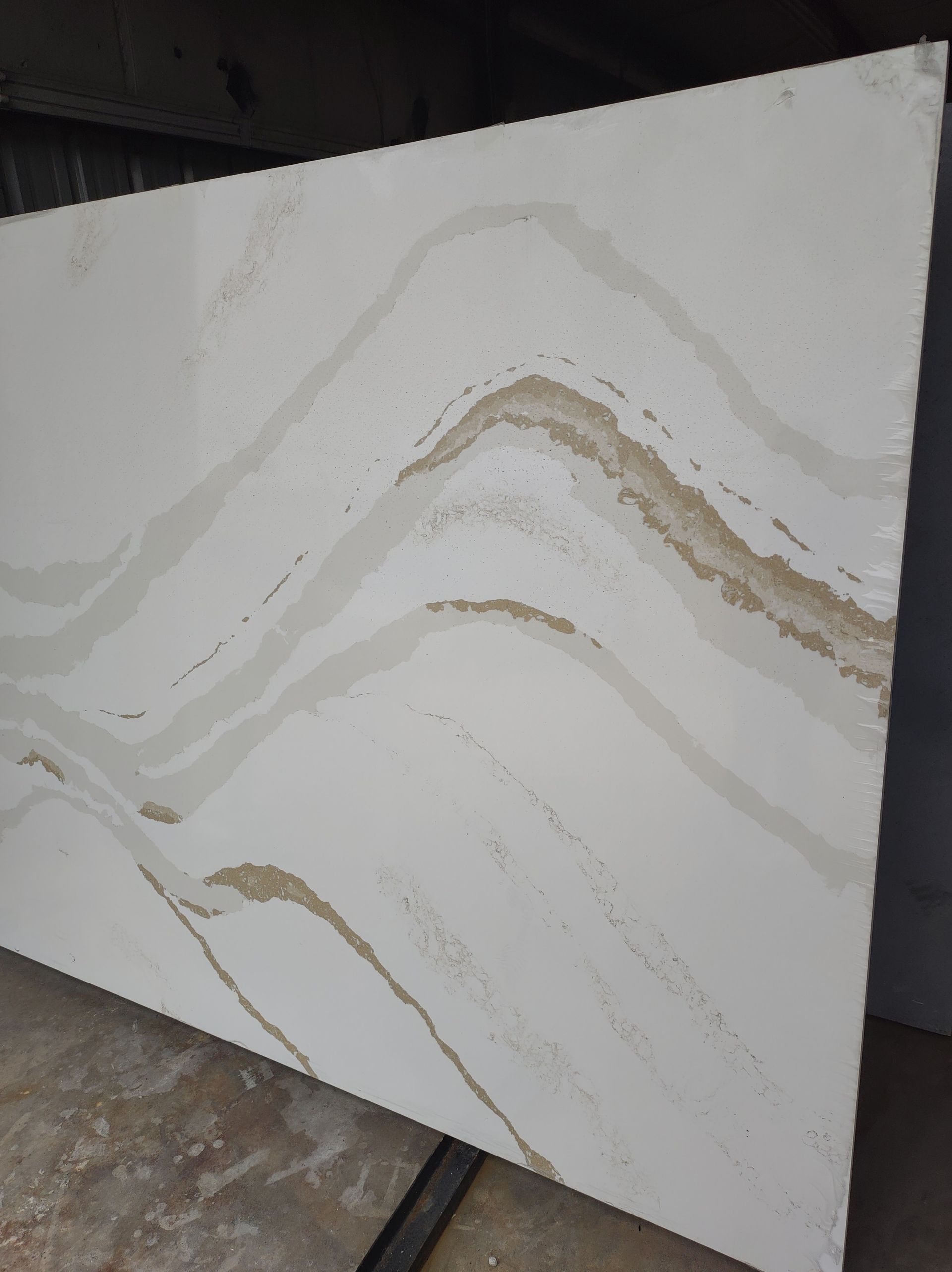 A piece of white marble with a swirl pattern is sitting on a table.