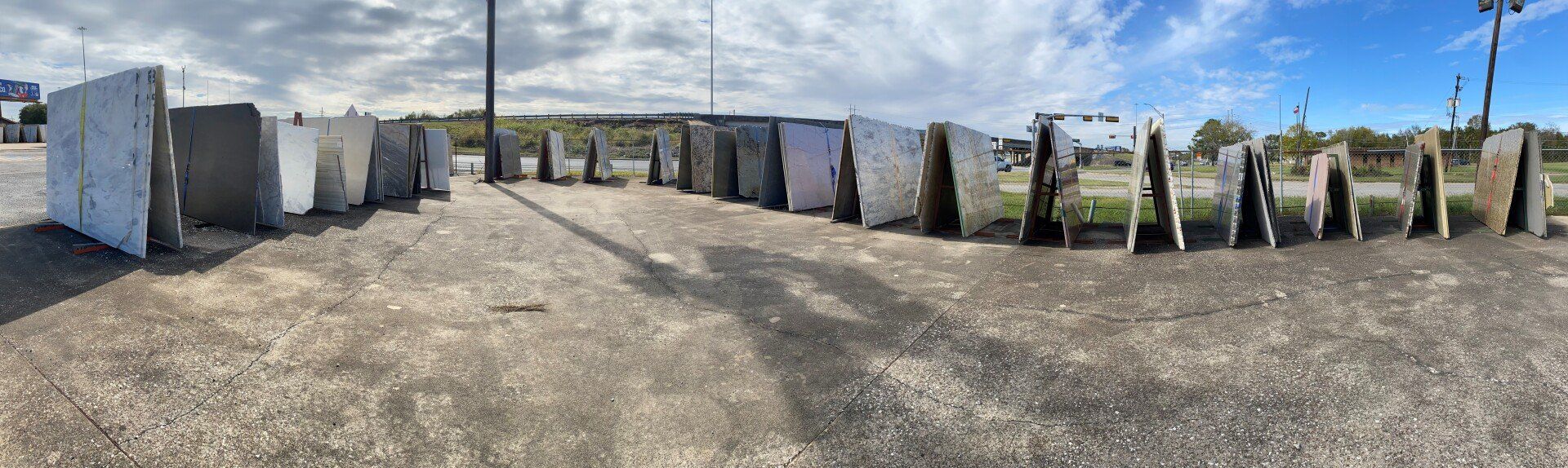 A row of concrete blocks sitting on top of a gravel road.