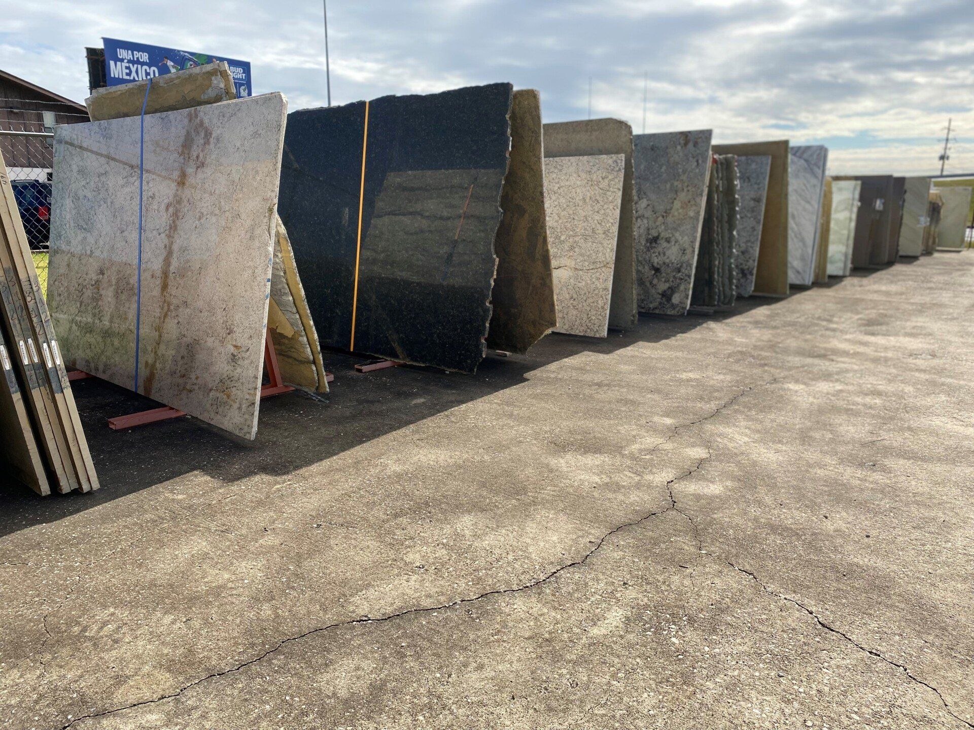 A row of marble slabs are lined up in a parking lot.