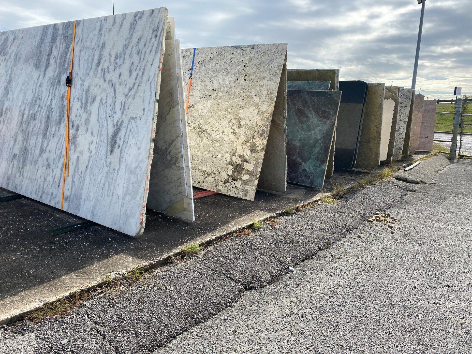 A row of marble slabs sitting on the side of a road.