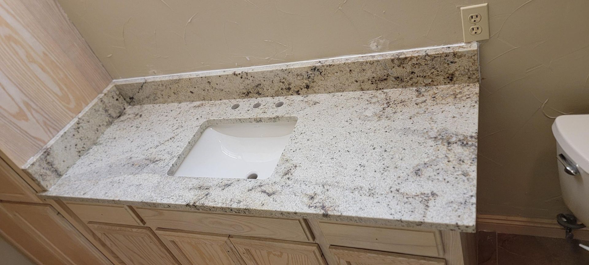 A kitchen with a large island and a sink.