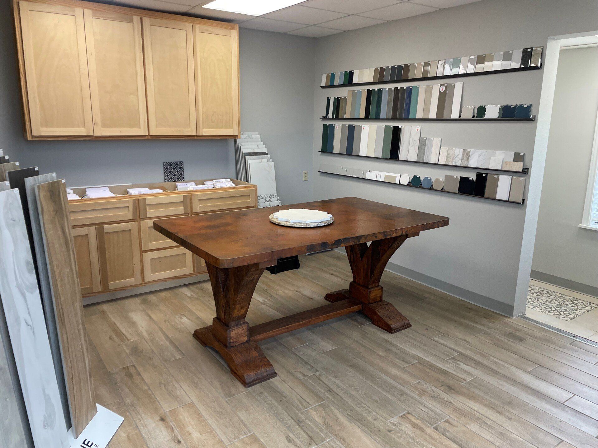 There is a wooden table in the middle of the room.