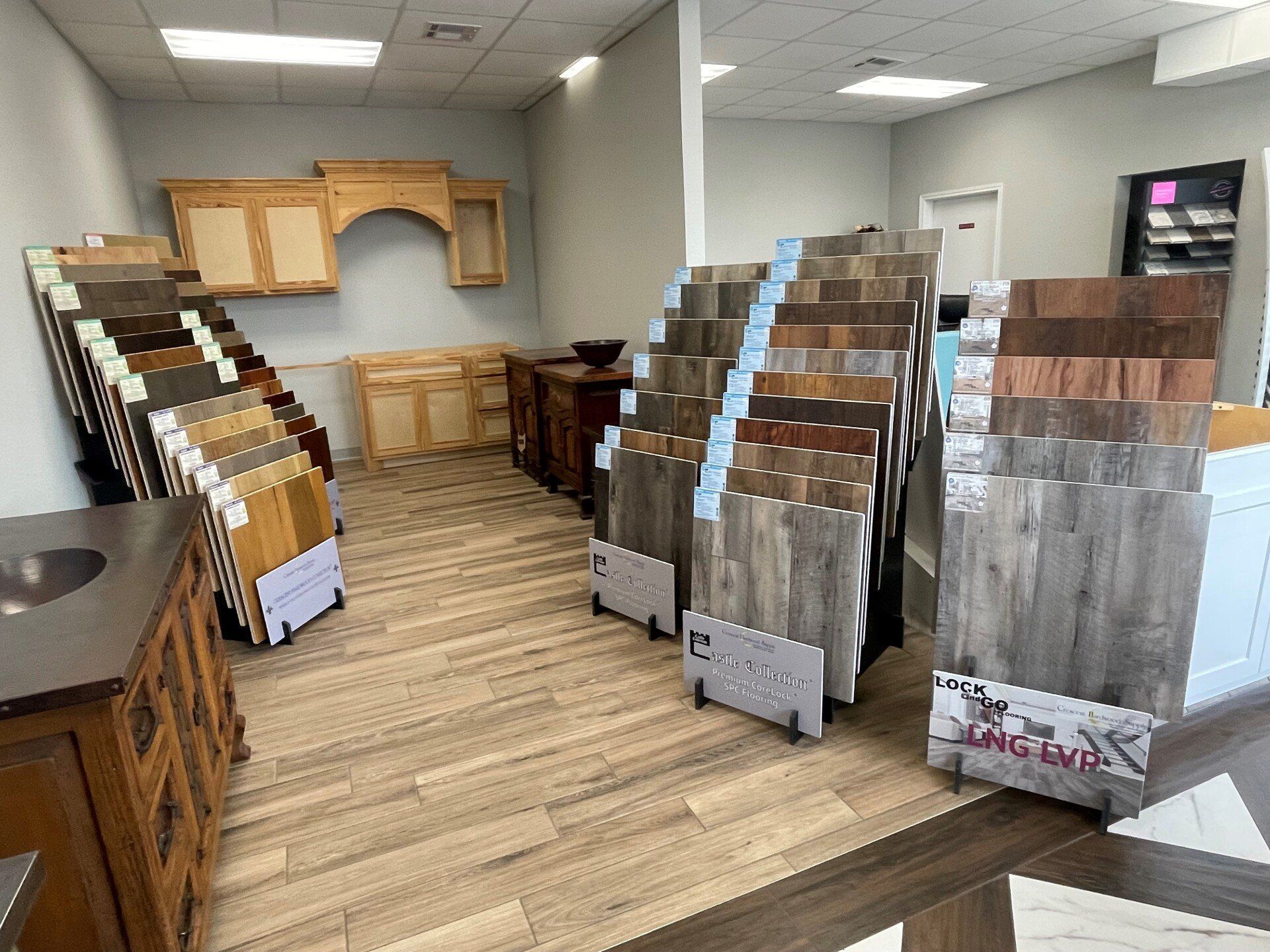 A showroom filled with lots of different types of flooring and cabinets.