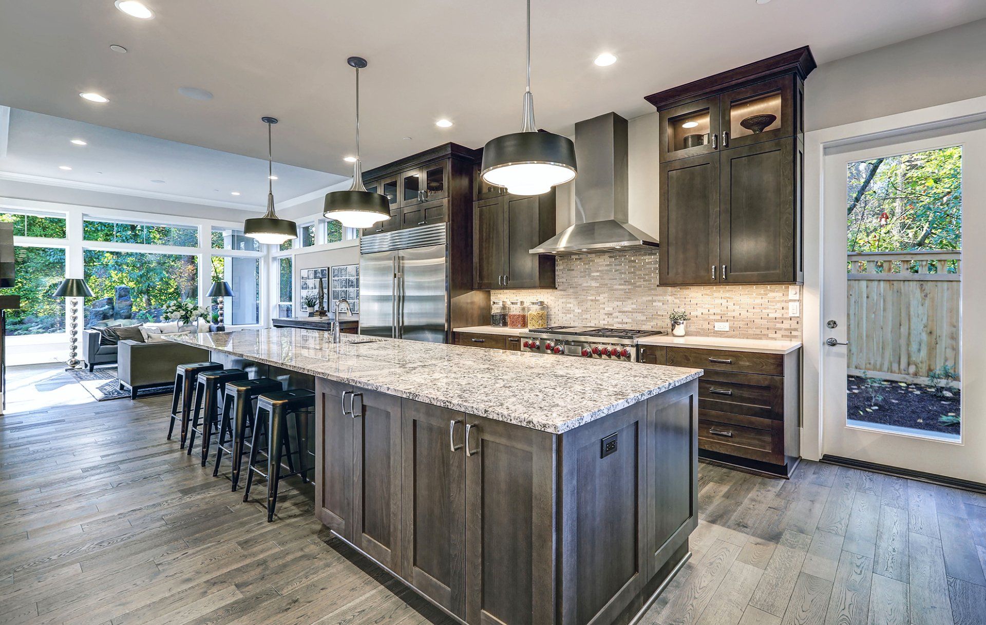 A large kitchen with granite counter tops and stainless steel appliances.