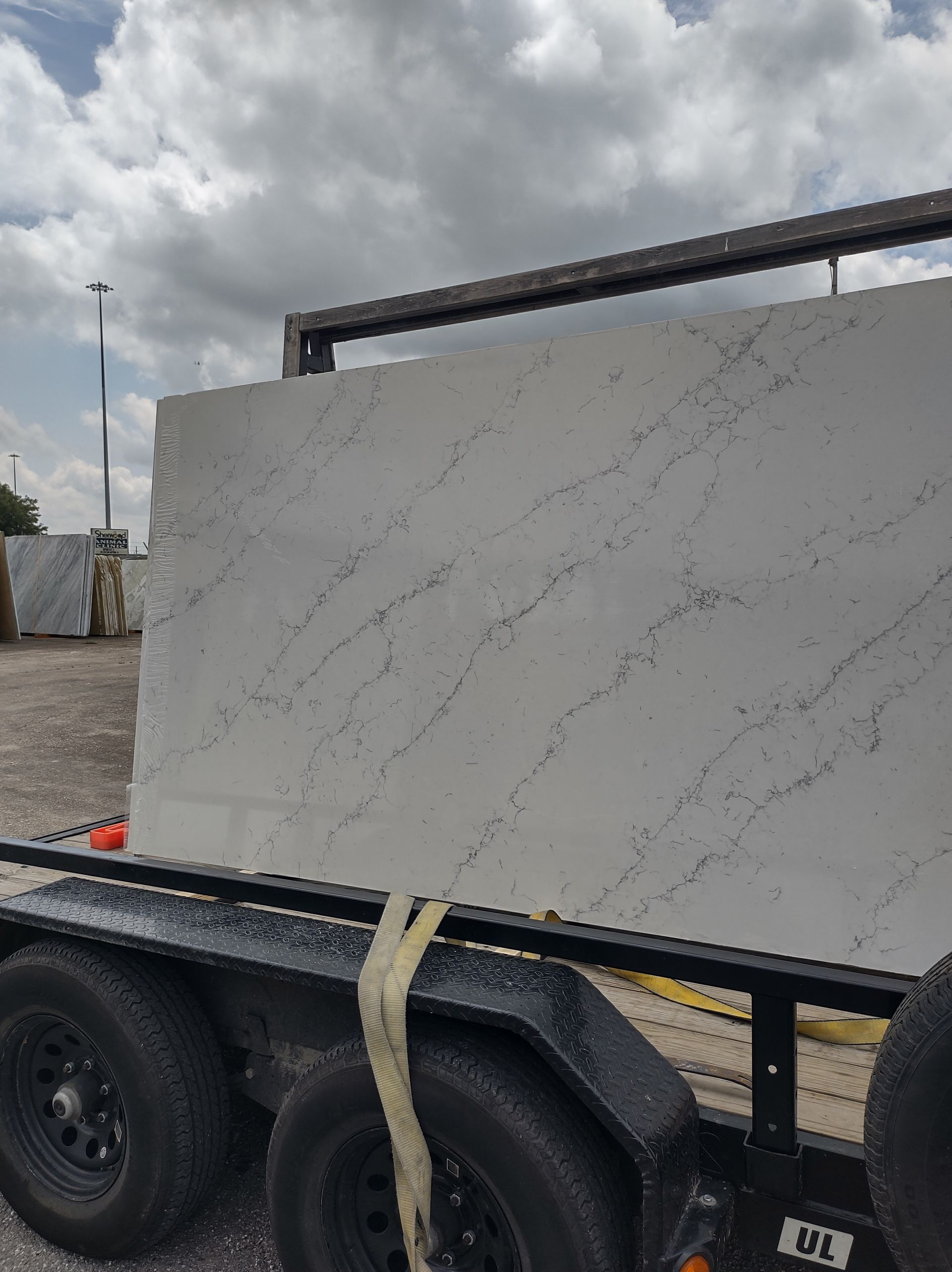 A trailer with a large white slab of marble on it.