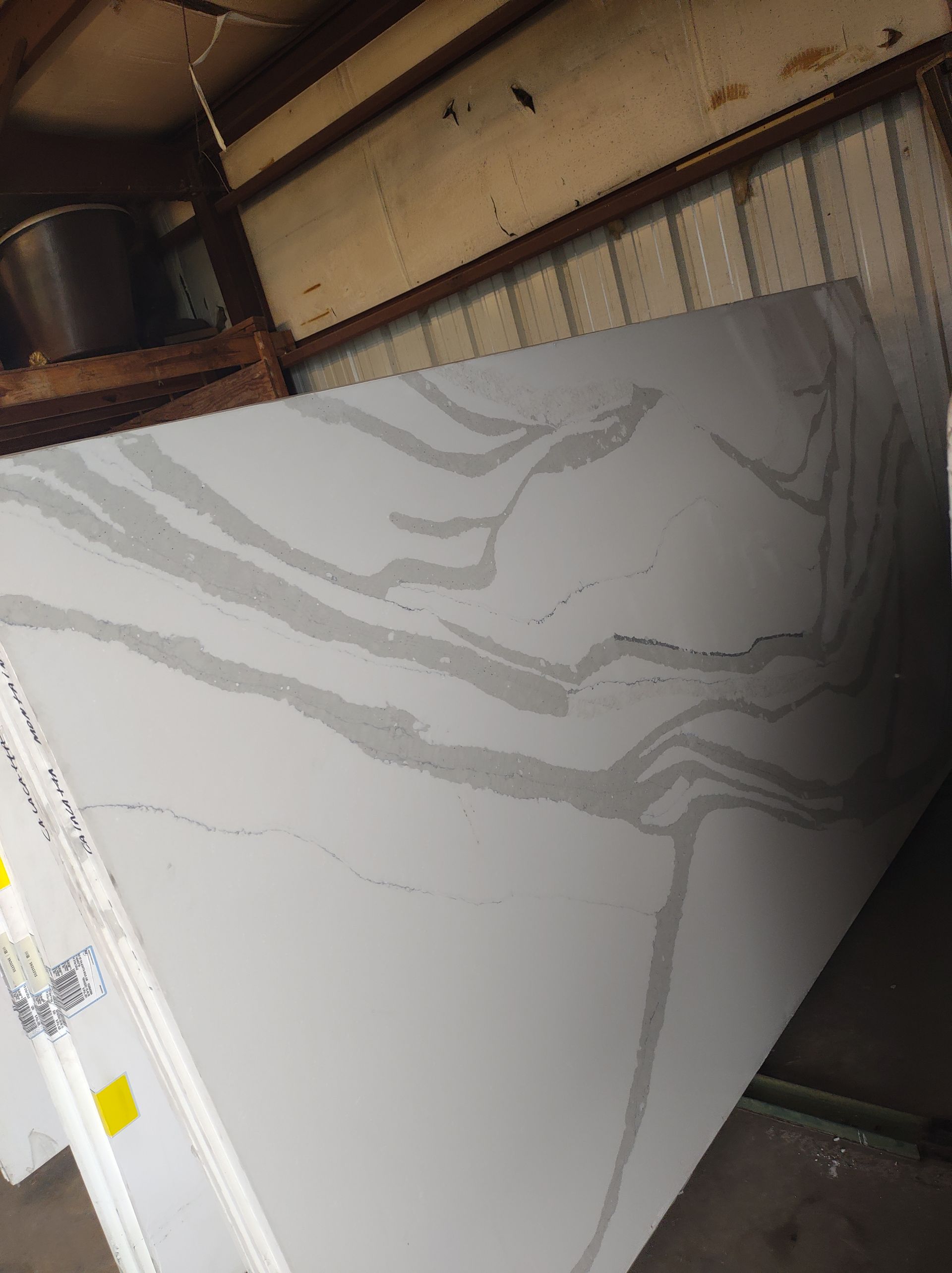 A large piece of white granite is sitting in a warehouse.