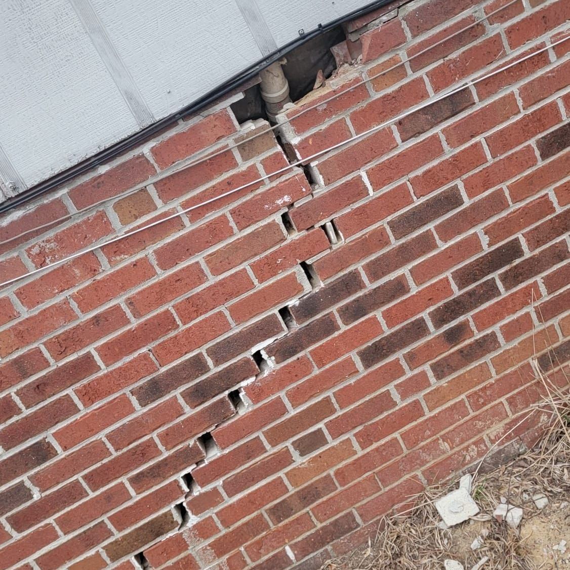 A close up of a brick wall with holes in it.