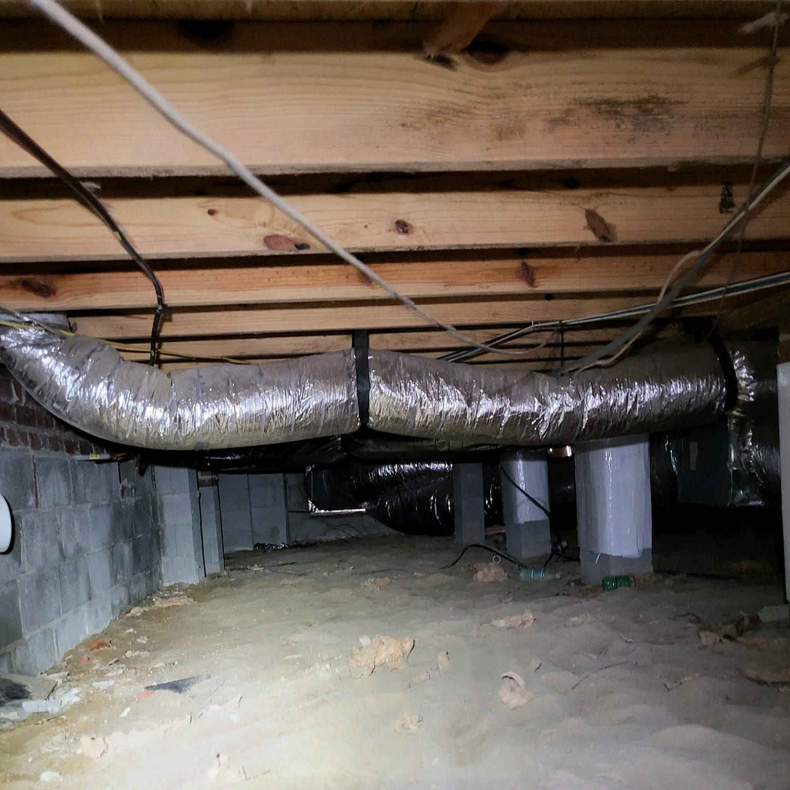 A basement with a lot of wires hanging from the ceiling