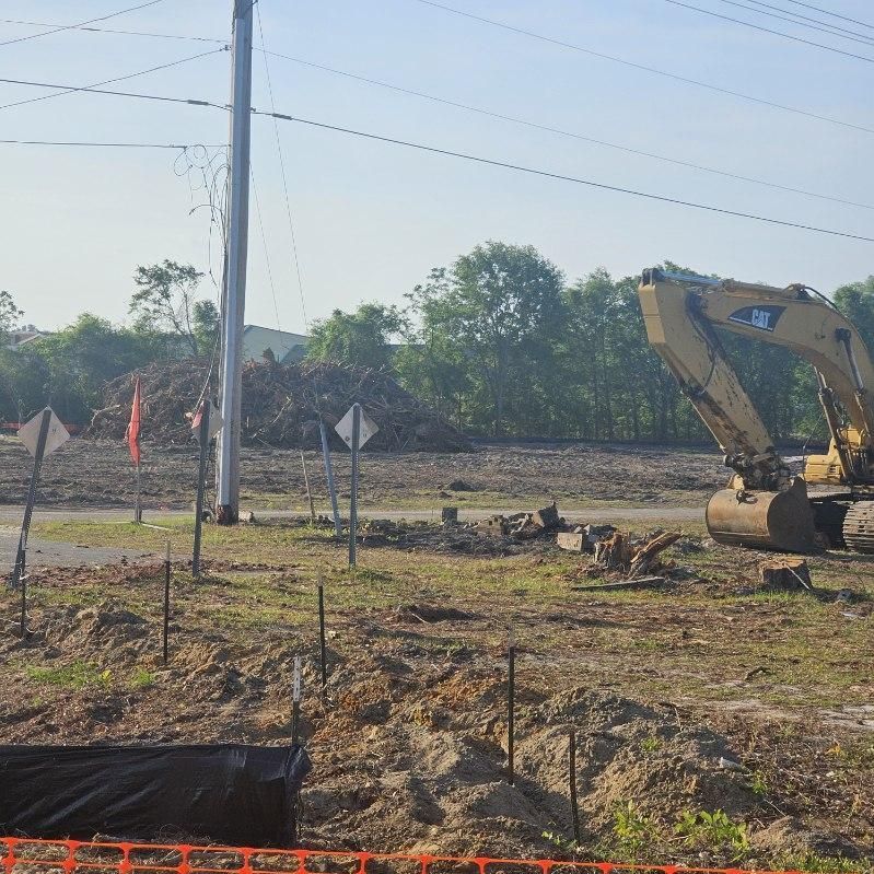 A cat excavator is working on a construction site