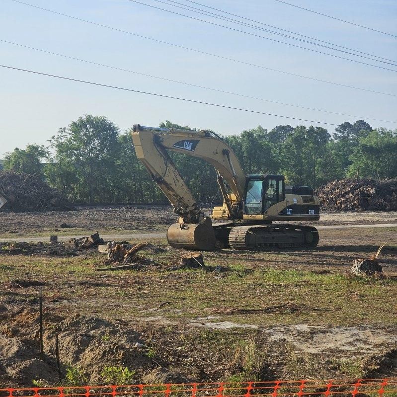 A yellow excavator with a cat logo on it