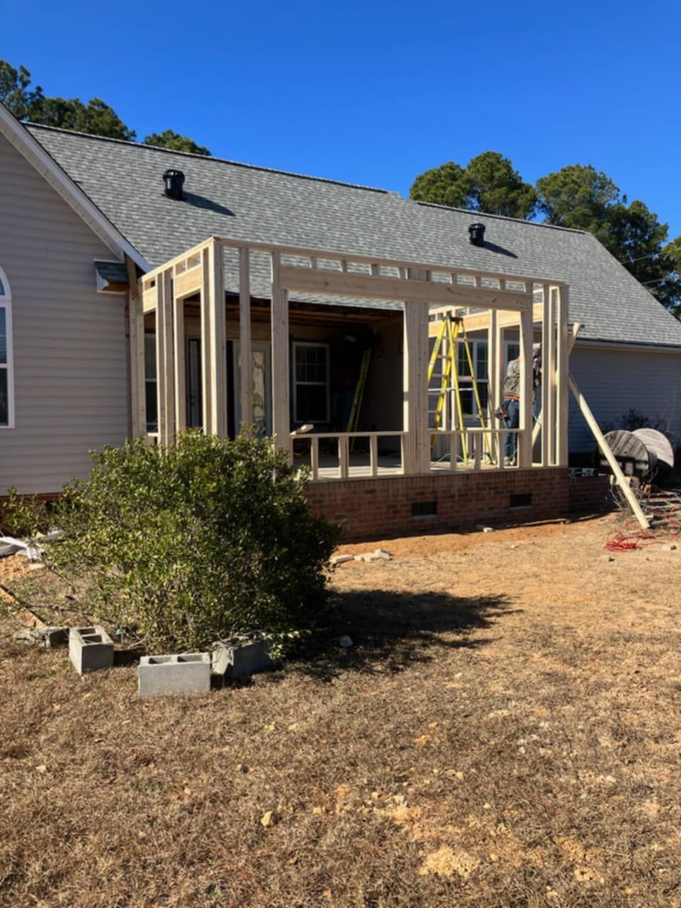 A house is being remodeled, and a porch is being built.