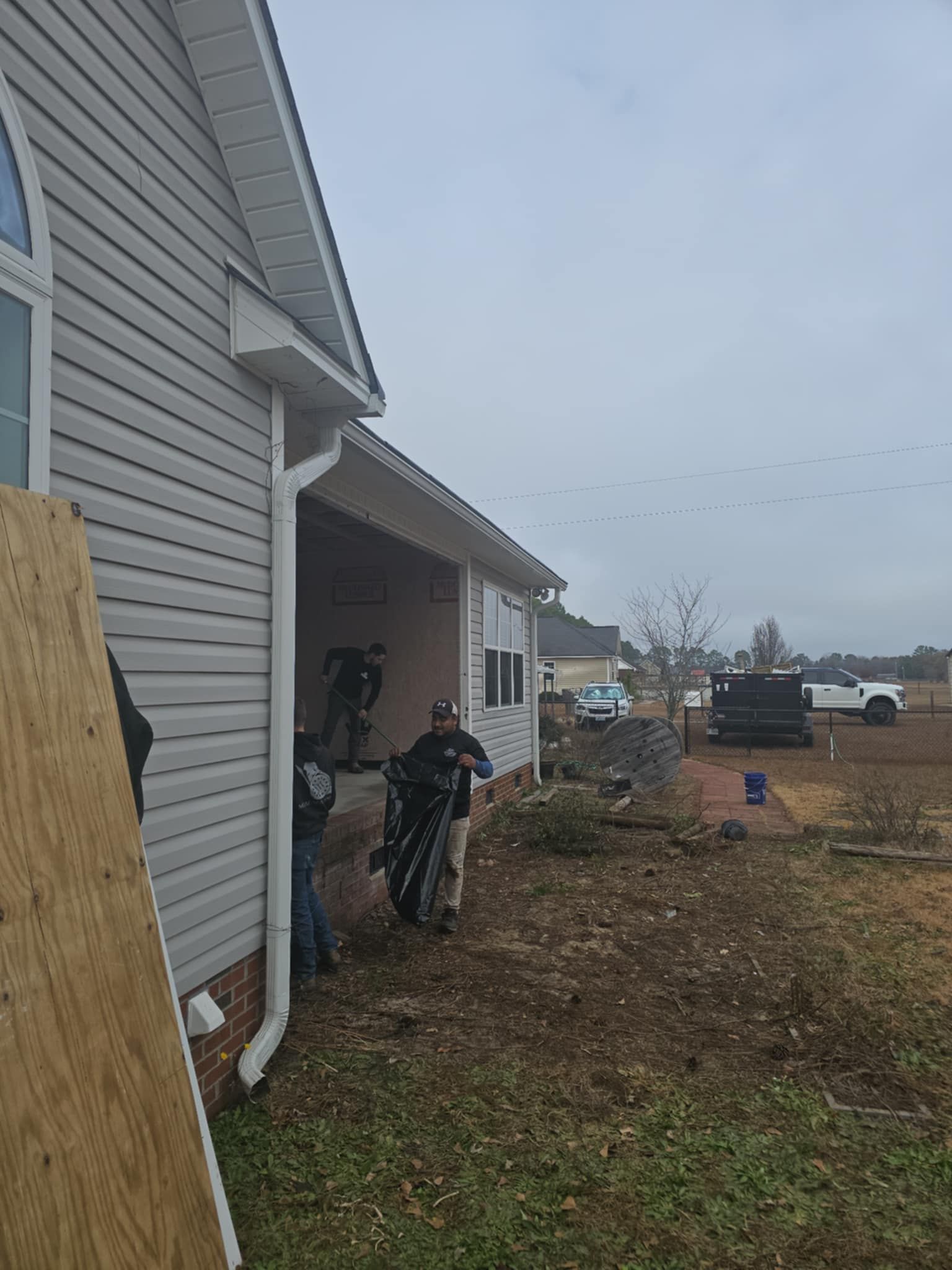 A group of people are standing in front of a house.