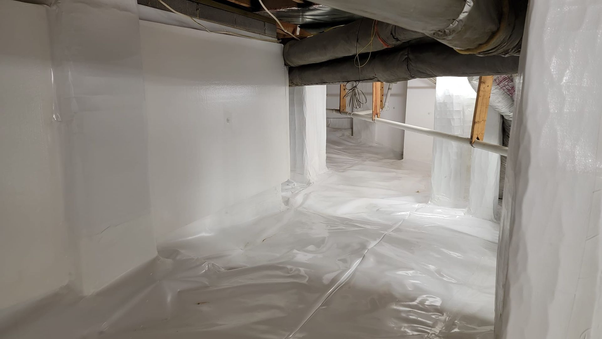 A flooded basement with a lot of water coming out of it.