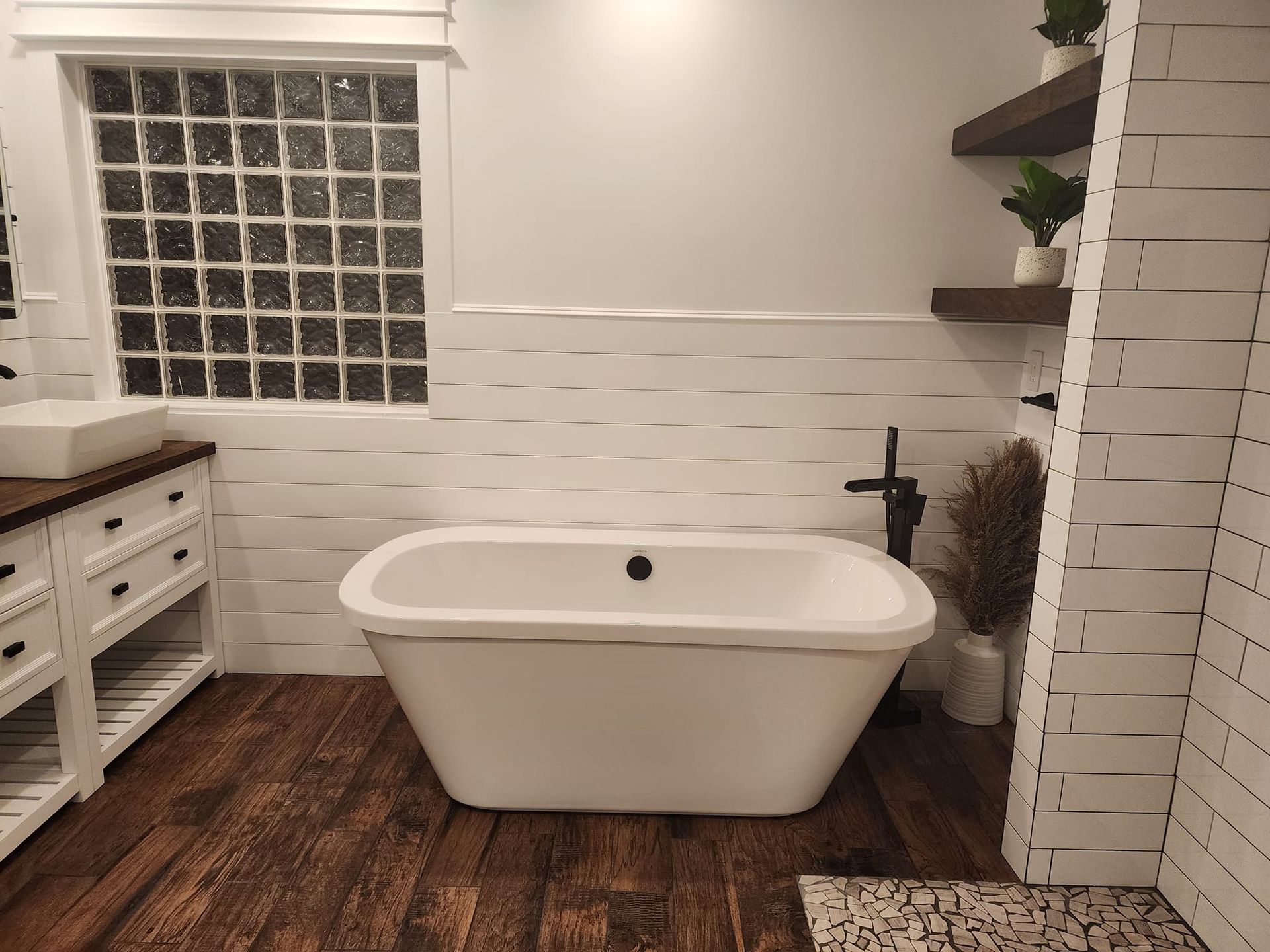 There is a bathtub in the middle of the bathroom.