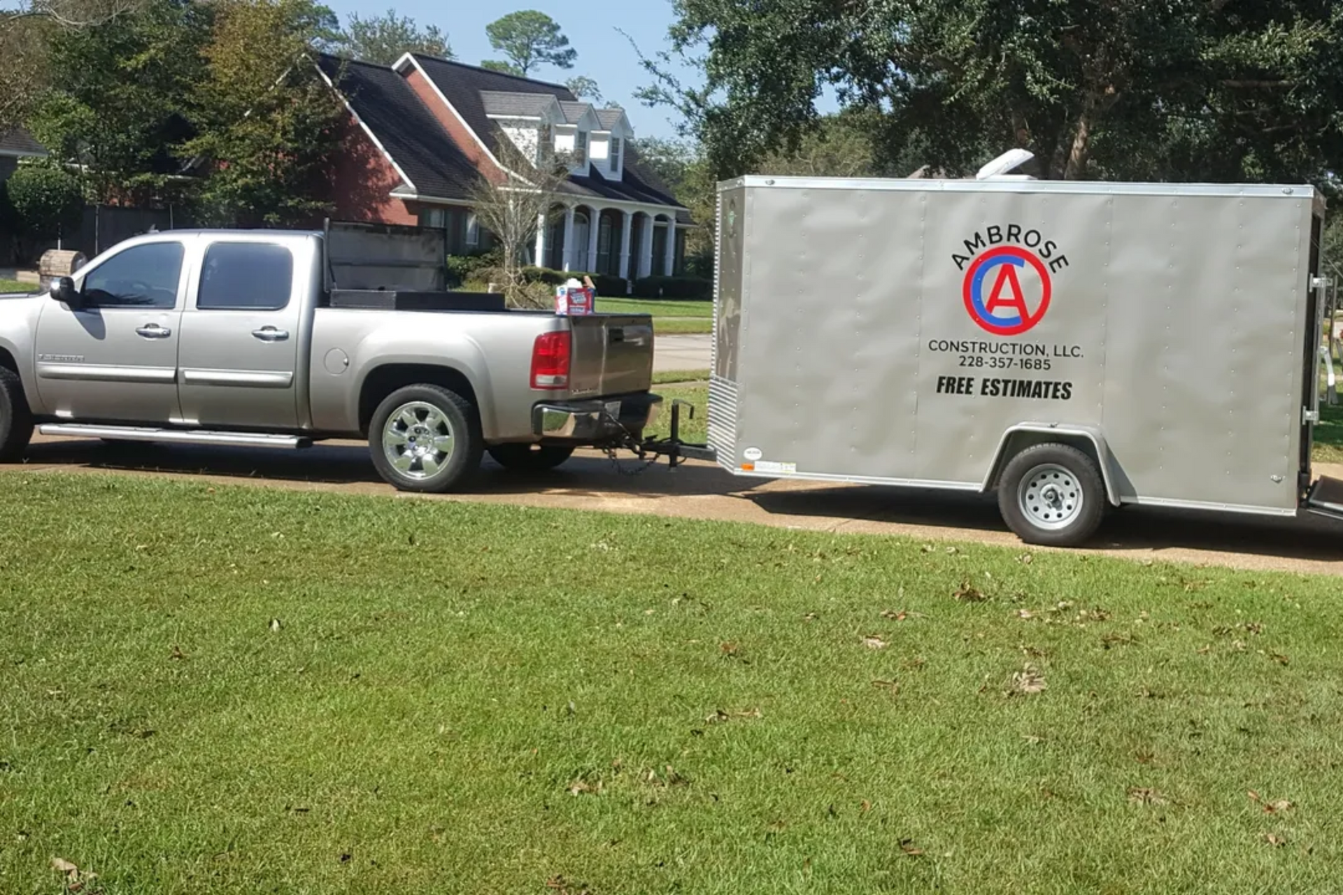 Silver pickup truck towing a silver trailer with 