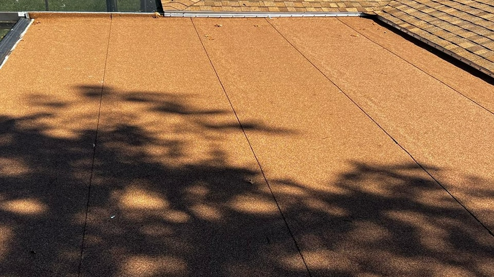 A roof with a shadow of a tree on it.