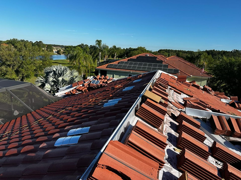 A roof with a lot of tiles and solar panels on it