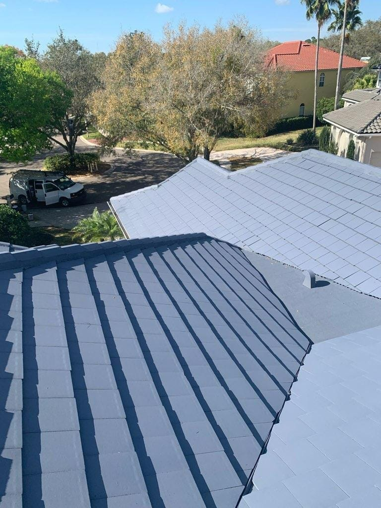 An aerial view of a roof with a car parked on the side of it.