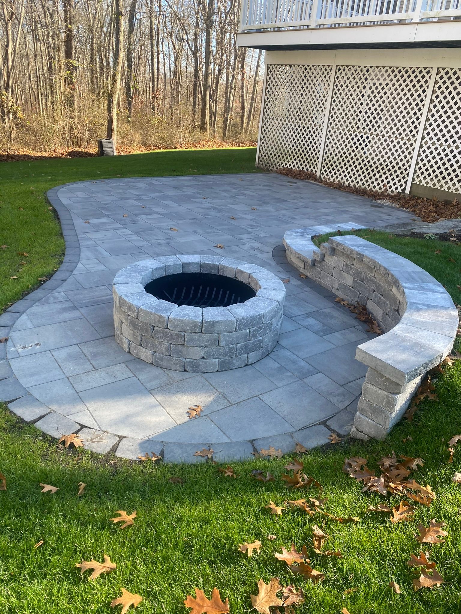 There is a fire pit in the middle of the patio.