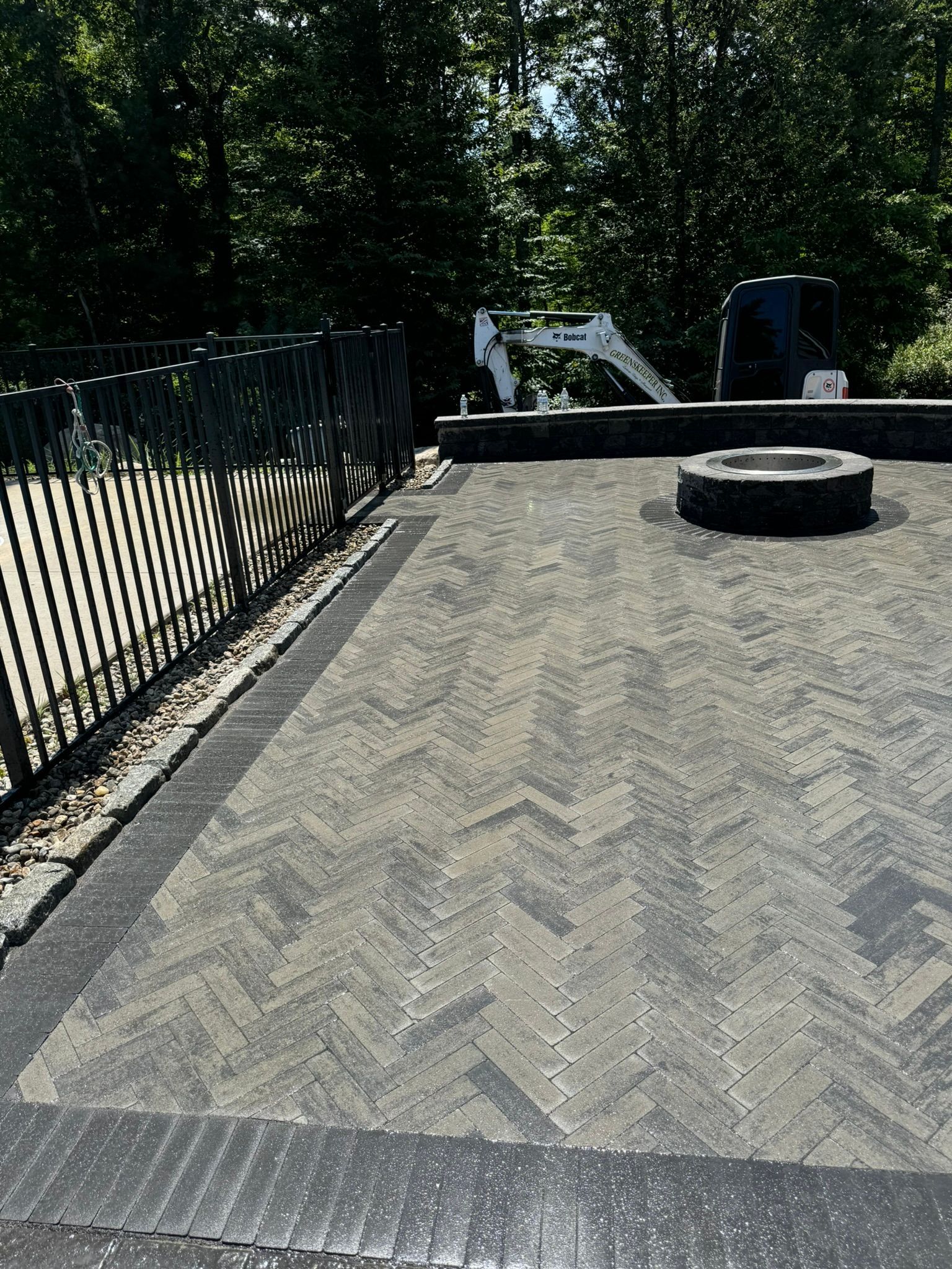 There is a fire pit in the middle of the patio.