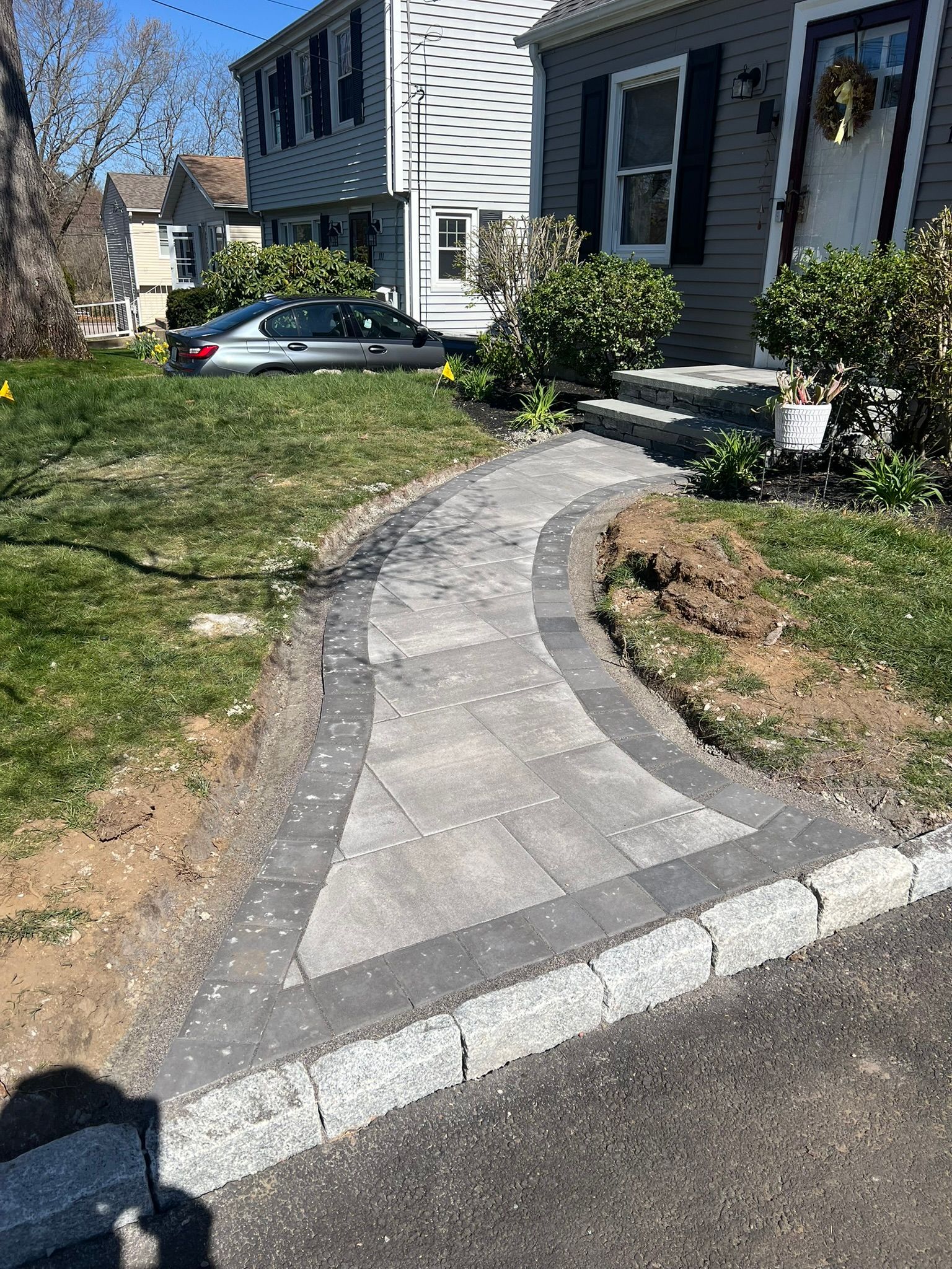 A walkway is being built in front of a house.