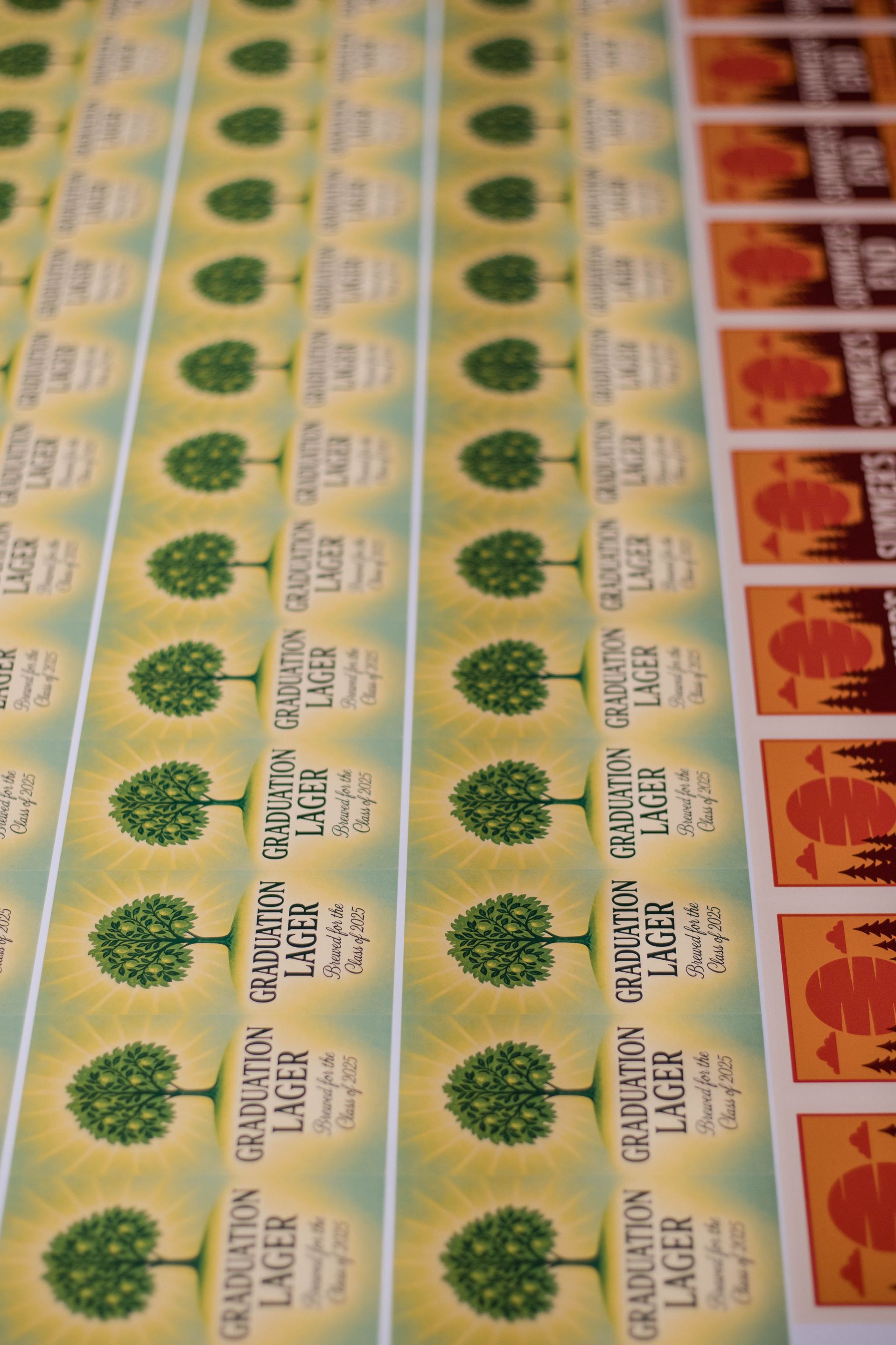 Rows of colorful postage stamps laid out in a sheet, with green and orange designs