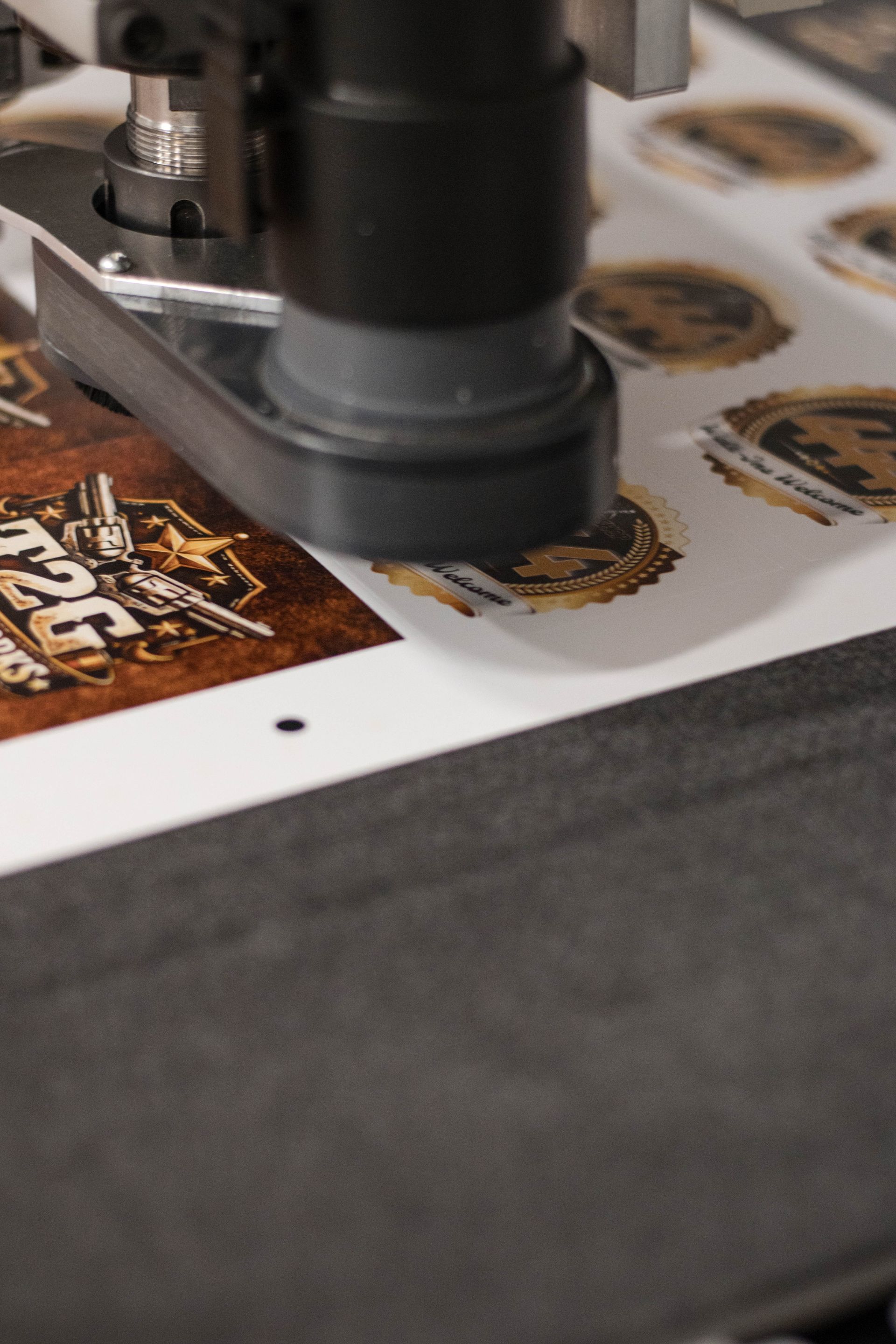Printing machine applying gold foil to cards on a sheet