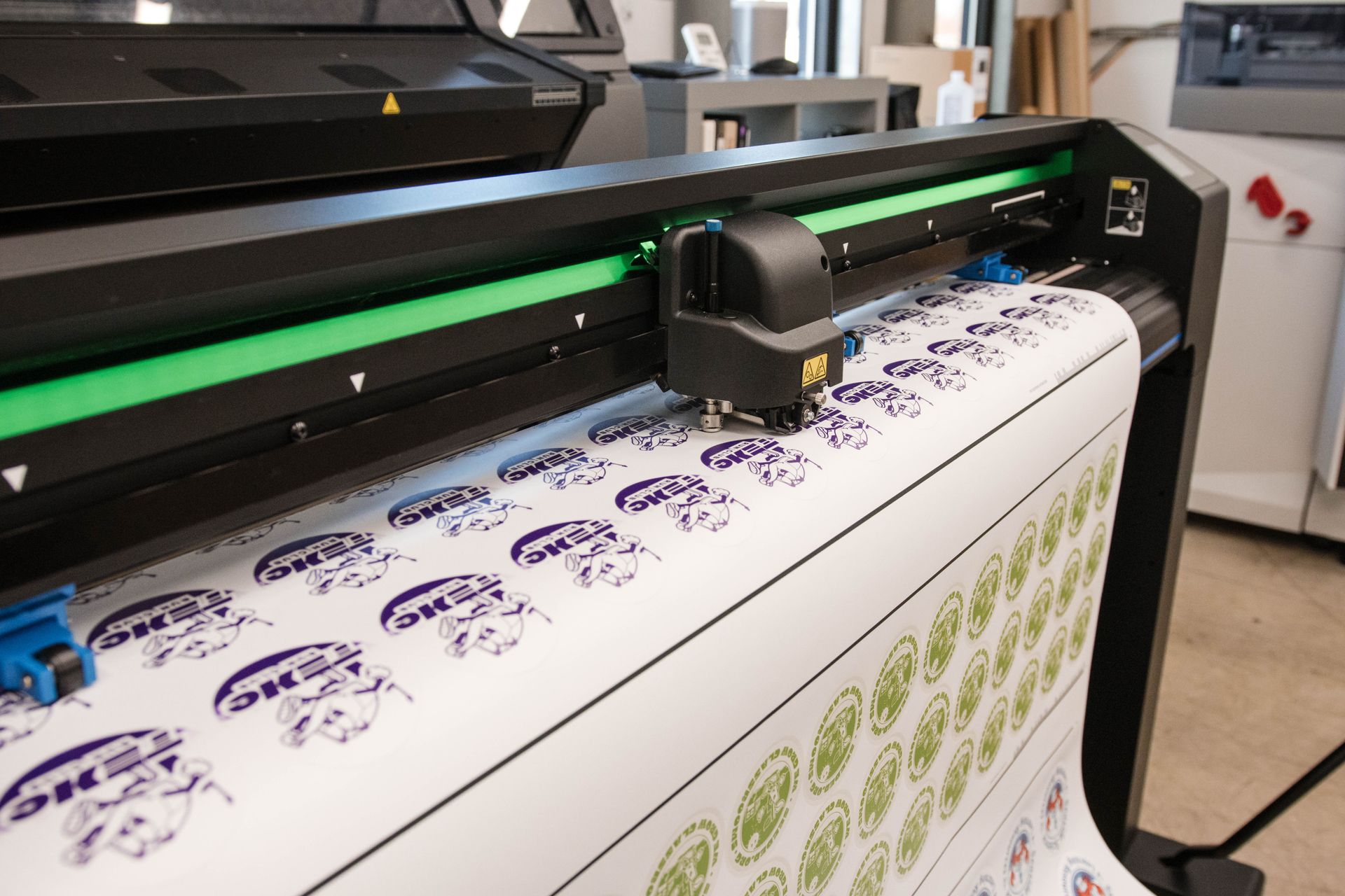 Large-format printer printing patterned fabric in a workshop