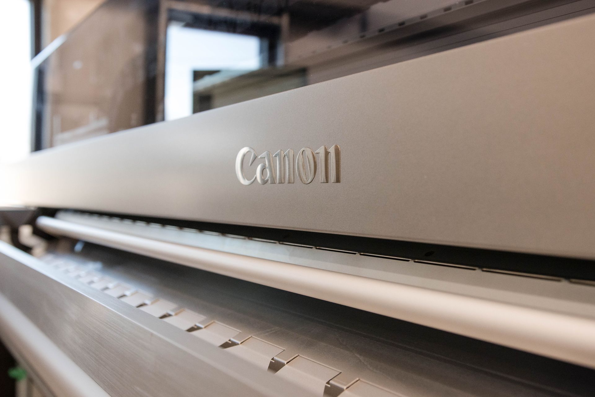 Close-up of a silver Canon printer with paper loaded in the tray