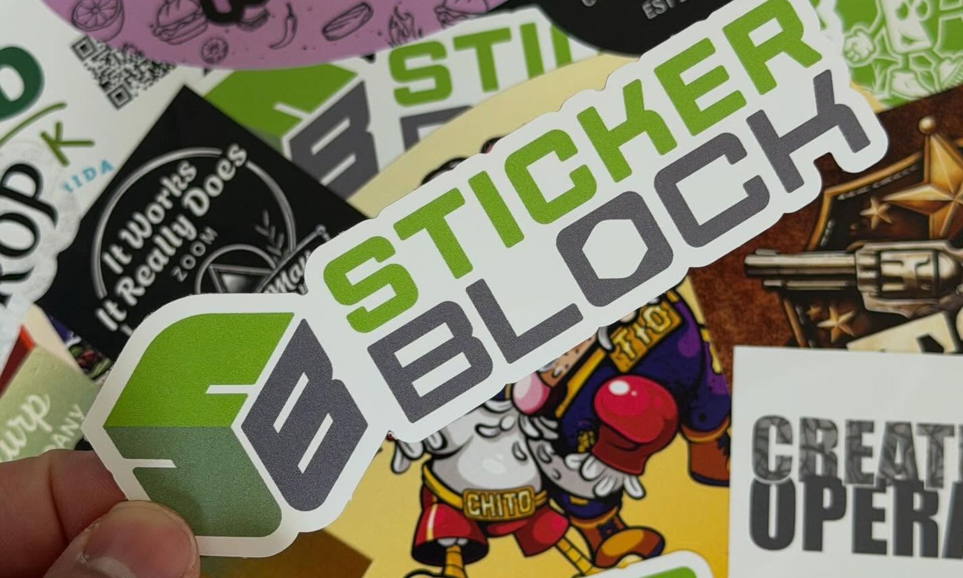 Assorted colorful sticker designs, including a large “STICKER BLOC” logo and graphic icons.