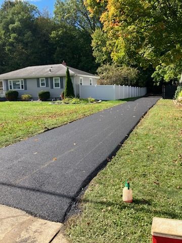 People preparing asphalt driveway for repair - after
