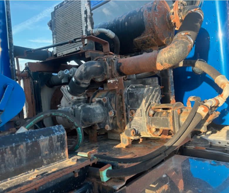 A close up of a rusty engine on a blue truck
